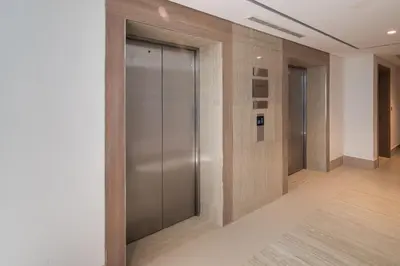 a hallway with elevator doors in a building at Modern Meydan Studio Near Dubai Mall & Downtown in Dubai
