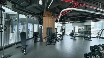 a gym with a lot of equipment in a building at Luxury 2BR Burj Khalifa and Canal View Pool Jacuzzi in Dubai