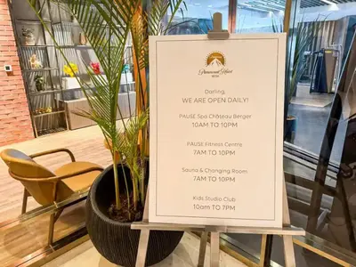 a menu in a store window with a plant at PARAMOUNT MIDTOWN RESIDENCES - A Luxury 2 BR Apartment near BURJ KHALIFA and DUBAI MALL in Dubai