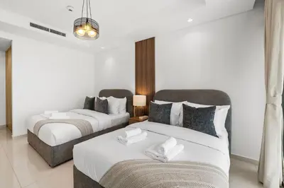a bedroom with two beds and a couch at PARAMOUNT MIDTOWN RESIDENCES - A Luxury 2 BR Apartment near BURJ KHALIFA and DUBAI MALL in Dubai