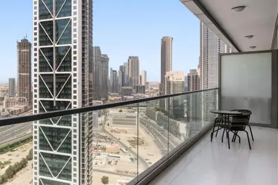 a balcony with a table and a view of a city at PARAMOUNT MIDTOWN RESIDENCES - A Luxury 2 BR Apartment near BURJ KHALIFA and DUBAI MALL in Dubai