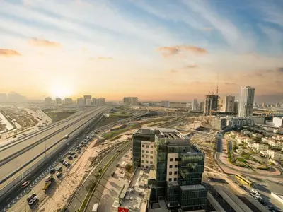 an overhead view of a city with traffic on a highway at Elegant and Spacious 2-Bedroom Apartment in JVT in Dubai