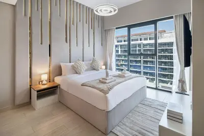 a bedroom with a bed and a large window at Luxury 2BR in Meydan Near Downtown & Dubai Mall in Dubai