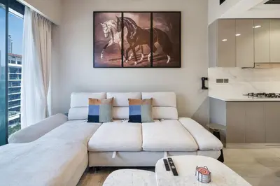 a living room with a couch and a horse painting on the wall at Luxury 2BR in Meydan Near Downtown & Dubai Mall in Dubai