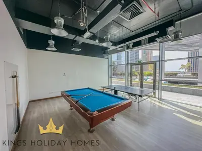 a pool table in a room with two ping pong tables at Central Park Towers Royal suite DIFC Downtown in Dubai