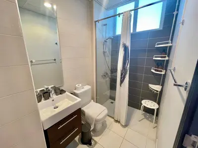 a bathroom with a toilet and a sink and a shower at Amazing 3BHK Townhouse in Damac Hills 2 upto 10PLL in Dubai