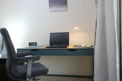 a desk with a computer on it with a chair at Cosy 1 bed in Dubai Marina in Dubai