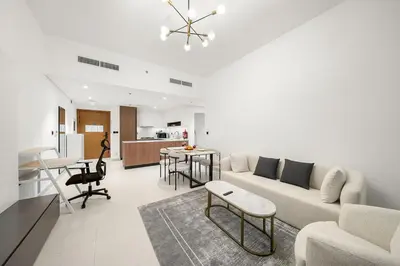 a living room with a couch and a table at FIRST CLASS 1BR Stylish Urban Retreat in Dubai