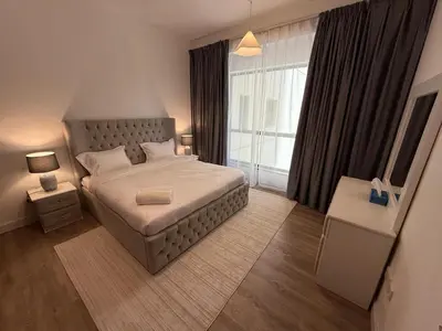 a bedroom with a large bed and a large window at 1BR Apartment JBR in Dubai