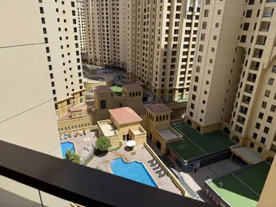 a model of a building with a pool and buildings at 1BR Apartment JBR in Dubai