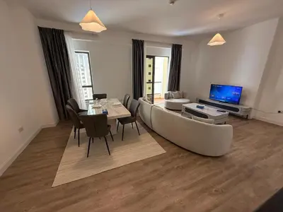 a living room with a couch and a table at 1BR Apartment JBR in Dubai