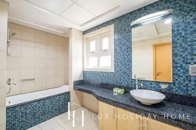 a bathroom with a sink and a mirror at LUX The Shoreline Palm Island Skyline Suite 2 in Dubai