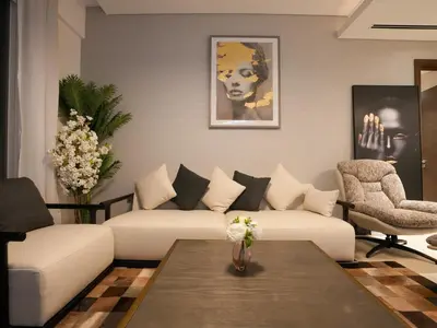 a living room with two couches and a table at Luxury 2BR in Sobha Hartland in Dubai