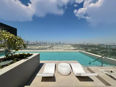 a view of a swimming pool from a building at Trophy-Aesthetic Apartment w Skyline and Dubai in Dubai