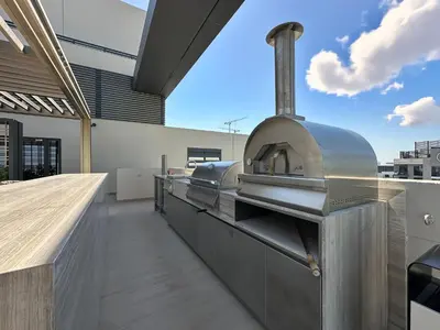 an outdoor kitchen with a pizza oven on a building at Trophy-Aesthetic Apartment w Skyline and Dubai in Dubai
