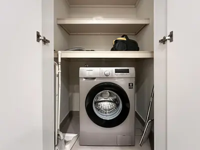 a washer and dryer in a small room at Trophy-Aesthetic Apartment w Skyline and Dubai in Dubai