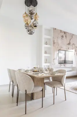 a dining room with a table and chairs at Luxury 4BR with Hermes Touch & Burj Khalifa View in Dubai
