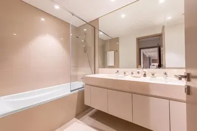 a bathroom with two sinks and a shower at Luxury 4BR with Hermes Touch & Burj Khalifa View in Dubai