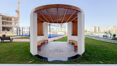 a group of benches sitting under a pavilion in a park at Modern Studio with all Amenities Ideal Location in Dubai