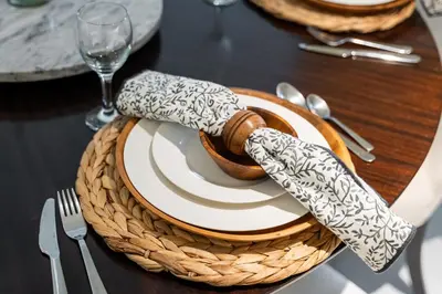 a wooden table with a plate and a knife and fork at Luxury 4BR Apartment in JBR Private Beach Access in Dubai