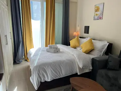 a small bedroom with a bed and a window at MarinaBliss in Dubai