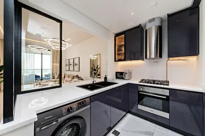 a kitchen with a washing machine and a sink at Luxury Apartment in Business Bay in Dubai