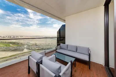a room with a large window with chairs and a table at Luxury Apartment in Business Bay in Dubai