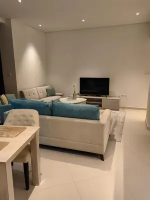a living room with a blue couch and a tv at 7 palm Jumeirah one bedroom in Dubai