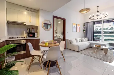 a kitchen and living room with a table and chairs at Boho 2bhk near Dubai mall with best nightlife in Dubai