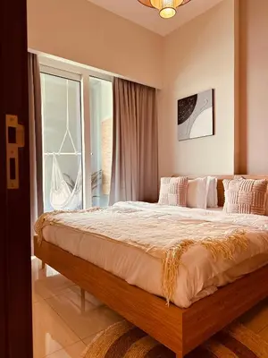 a bedroom with a large bed and a window at Boho 2bhk near Dubai mall with best nightlife in Dubai