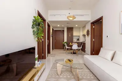 a living room with a white couch and a table at Boho 2bhk near Dubai mall with best nightlife in Dubai