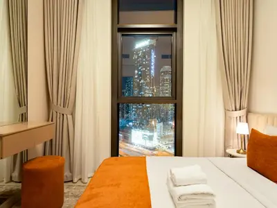 a bedroom with a window with a view of a city at Modern 1BR in DOWNTOWN I Near DUBAI MALL & FOUNTAIN in Dubai