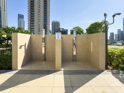 a concrete wall in a city with tall buildings at Modern 1BR in DOWNTOWN I Near DUBAI MALL & FOUNTAIN in Dubai