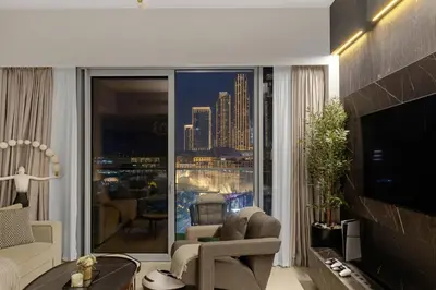 a living room with a view of a city at Gogoto2 Lux Burj Khalifa View 5 min Dubai Mall PS5 NYE Fireworks View in Dubai