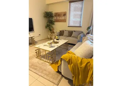a living room with a couch and a table at Centrally Located in Business Bay - Huge 1 Bedroom Hall in Executive Towers in Dubai