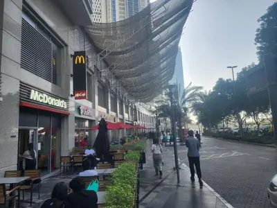 a group of people walking down a city street at Centrally Located in Business Bay - Huge 1 Bedroom Hall in Executive Towers in Dubai