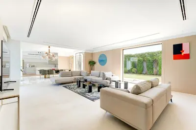 a living room with a couch and a table at Resort Villa 19 in Dubai