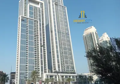 a large building with two skyscrapers in a city at Cozy & Modern 1 Bedroom Apartment in Downtown Dubai, Hosted by Desert City Stays in Dubai