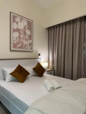a bedroom with two white beds and a window at Azizi riviera luxury studio apartment monthly rent in Dubai