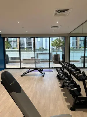 an empty gym with rows of chairs and windows at Azizi riviera luxury studio apartment monthly rent in Dubai