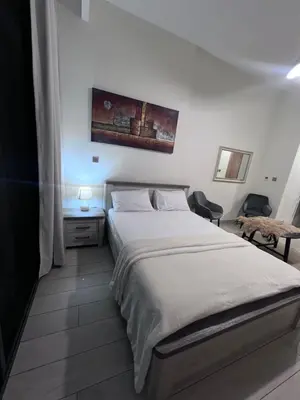 a bedroom with a large white bed in a room at Azizi riviera luxury studio apartment monthly rent in Dubai