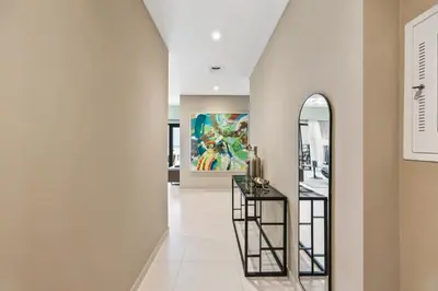 a hallway with a mirror and a painting on the wall at Walk to Dubai Mall- Enjoy Burj Khalifa Show in Dubai