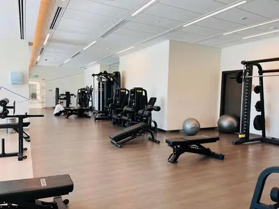 a gym with rows of exercise bikes and weights at Walk to Dubai Mall- Enjoy Burj Khalifa Show in Dubai