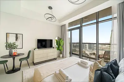 a bedroom with a bed and a television and a table at Silkhaus Cozy Studio at Business Bay in Aykon City in Dubai