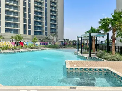 a swimming pool with a gazebo next to a building at Silkhaus Cozy Studio at Business Bay in Aykon City in Dubai
