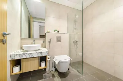 a bathroom with a toilet and a sink and a shower at Silkhaus Cozy Studio at Business Bay in Aykon City in Dubai