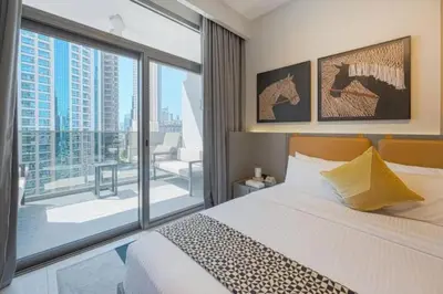 a bedroom with a bed and a large window at CAICAI Homes Mag 318 Dubai Walking Distance to Dubai Mall in Dubai