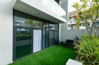 an internal courtyard of a house with green grass at Stylish Retreat - Embrace the Comfort in Dubai