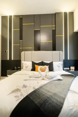 a bedroom with a large bed with a large white bedspread at Stylish Retreat - Embrace the Comfort in Dubai