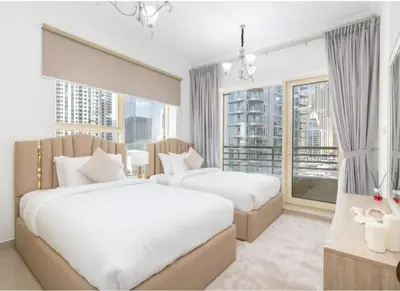 a bedroom with two beds and a large window at Dubai Marina-short stay in Dubai